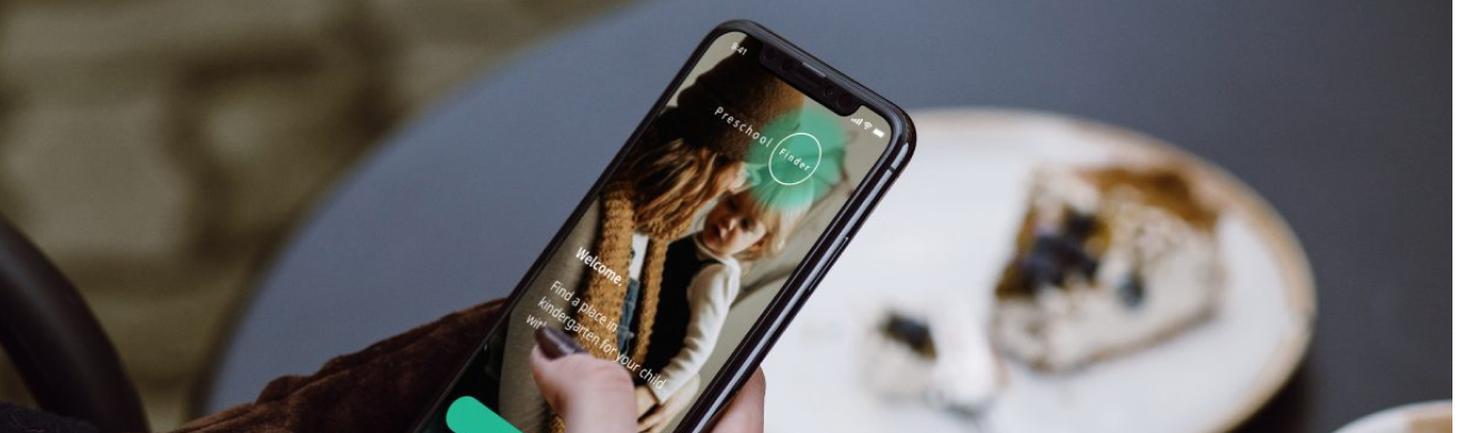 Woman checking free kindergarten spots on her smartphone